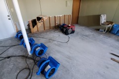Equipment in use for drying out bottom of subfloor
