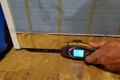 moisture meter measuring the moisture content of paneling