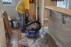 vacuuming dust from sanding