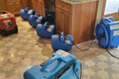 air movers drying out cabinets from water damage